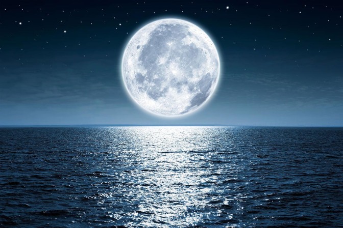 50220944 - full moon rising over the ocean empty at night with copy space